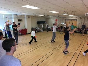 Parents & kids warm-up together for fencing